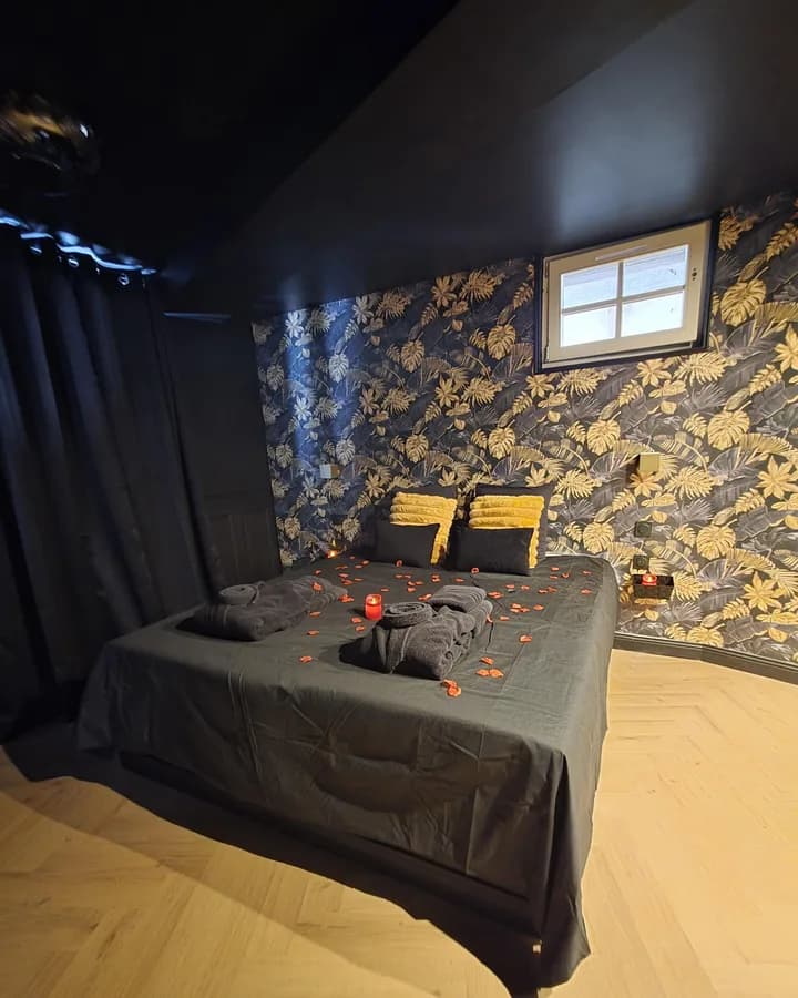 Chambre au papier peint végétal doré dans un logement géré à Châlons-en-Champagne